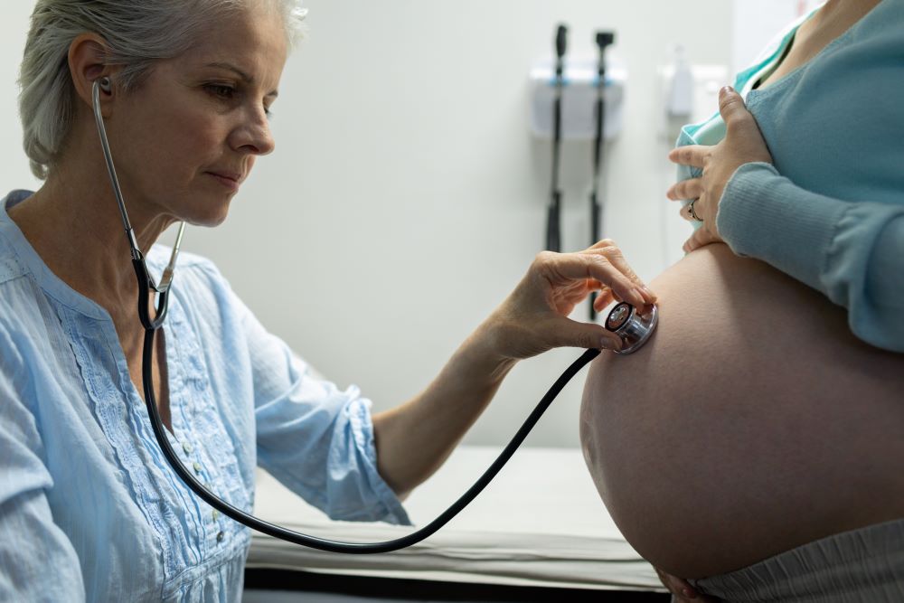 female doctor examining pregnant woman