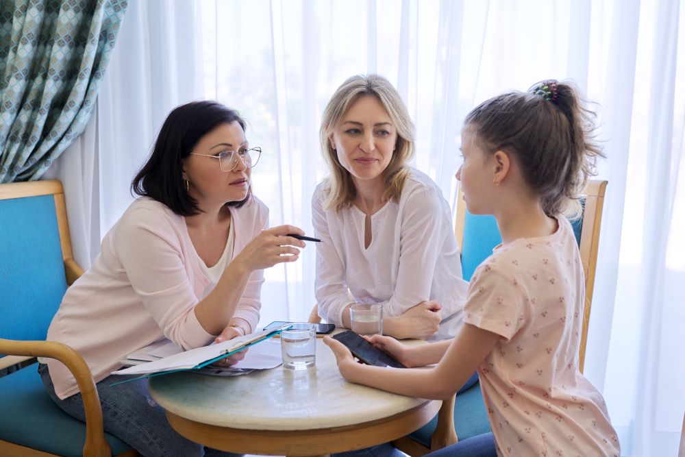Mom and daughter preteen child at meeting with psychologist