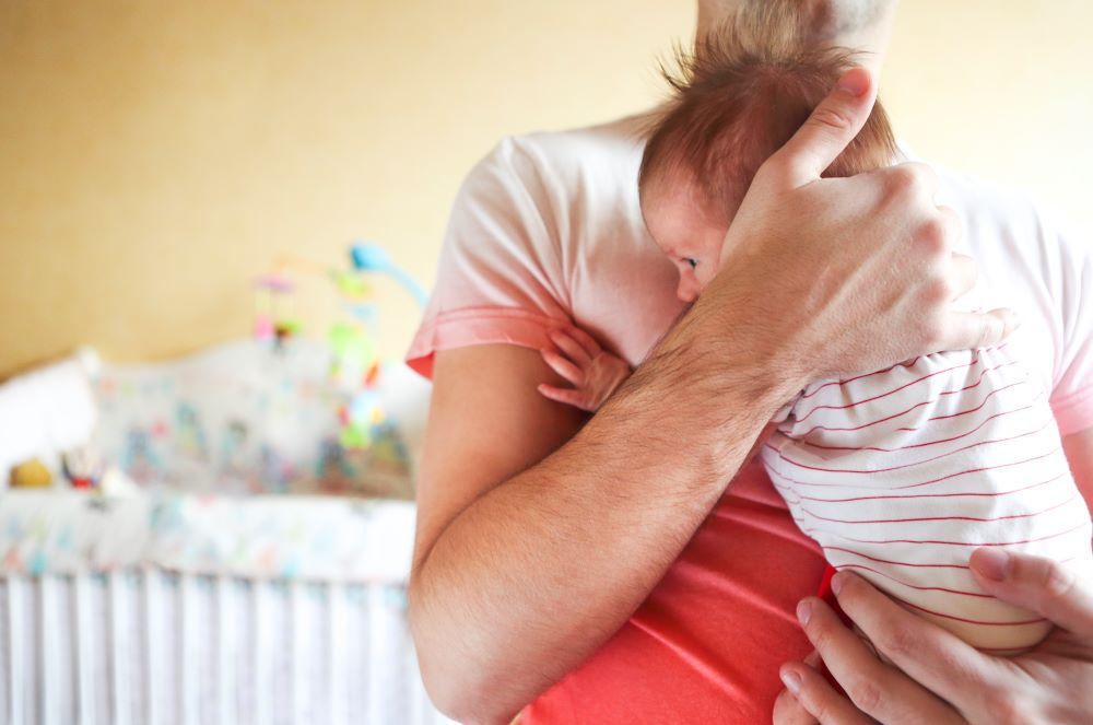 Father and his newborn baby daughter