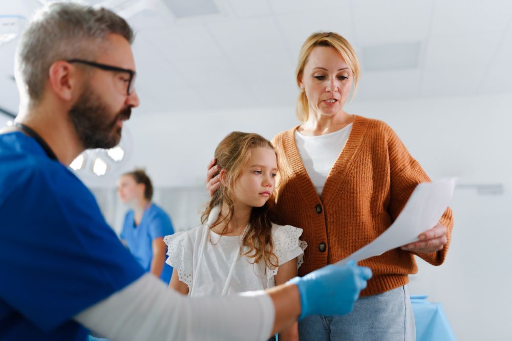 Doctor explaining something to mother of little girl
