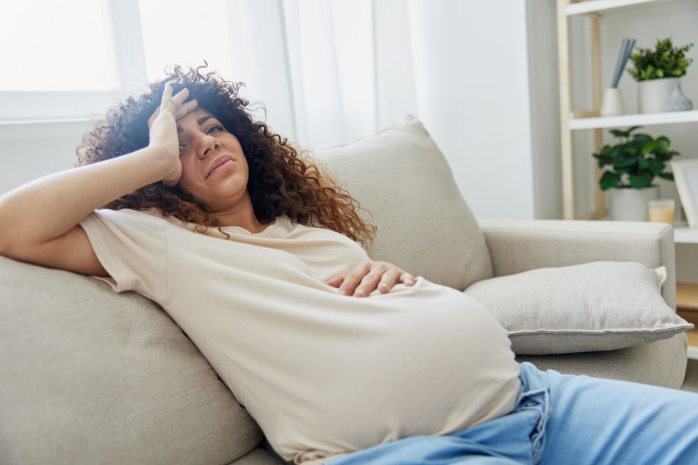Pregnant woman sitting on the couch